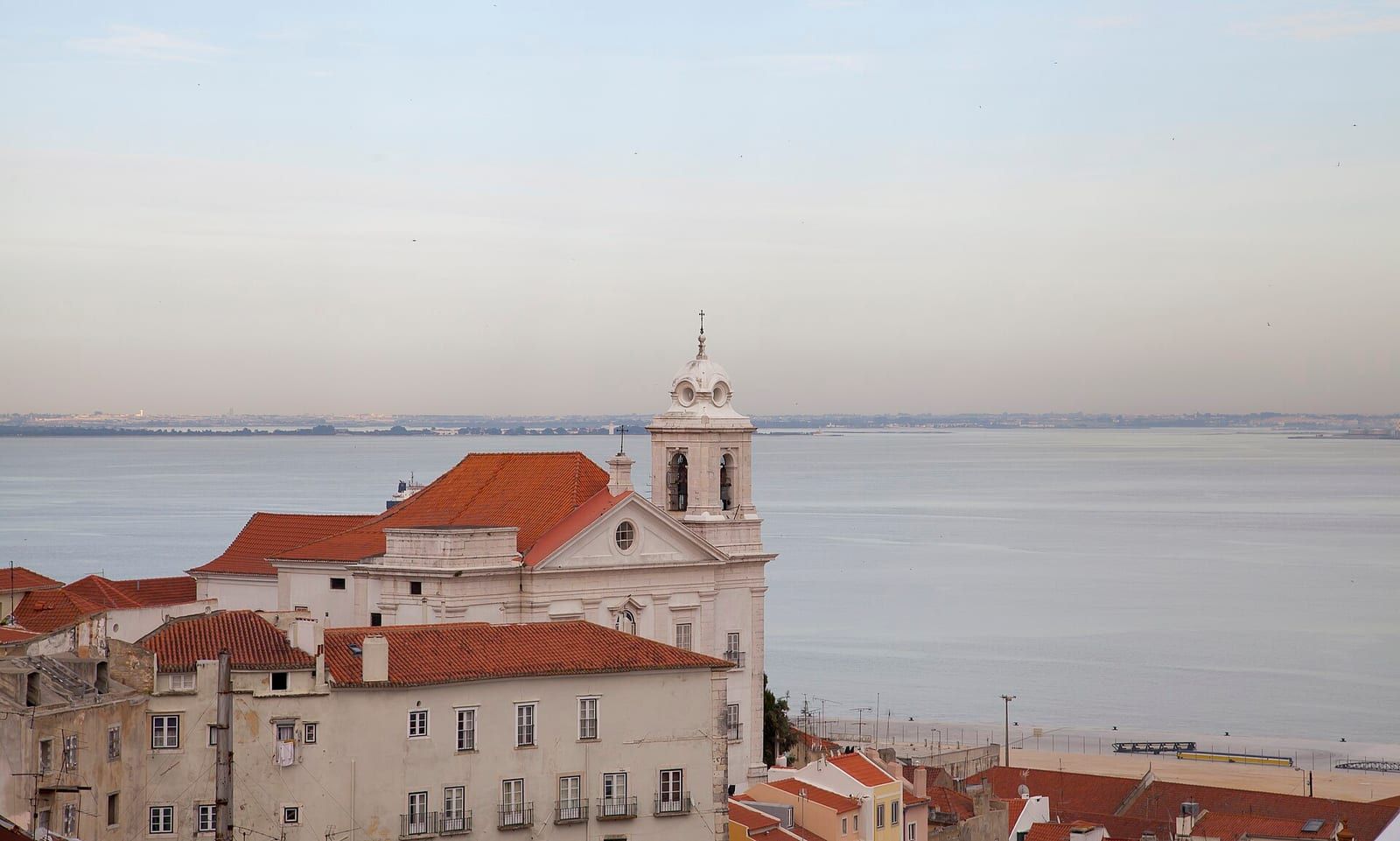 Lisbon rooftops and the Tagus river from the Santa Luzia viewpoint